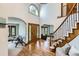 Grand foyer features hardwood floors, staircase and natural light at 16247 E Belleview Pl, Centennial, CO 80015