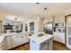 Bright kitchen features white cabinetry, stainless steel appliances and an eat-in island with pendant lighting at 16247 E Belleview Pl, Centennial, CO 80015