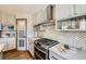 Well-appointed kitchen featuring stainless steel appliances and gray marbled countertops and backsplash at 16247 E Belleview Pl, Centennial, CO 80015