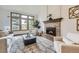 Cozy living room with fireplace, large windows and natural light at 16247 E Belleview Pl, Centennial, CO 80015