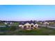 Stunning aerial view of a modern farmhouse with a cozy front porch and fire pit in a neighborhood at 2741 Morning Run Ct, Franktown, CO 80116