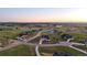 Expansive aerial view of a neighborhood with well-maintained homes, winding roads, and lush greenery at 2741 Morning Run Ct, Franktown, CO 80116