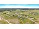 Wide aerial shot of a sprawling community with custom homes, surrounded by rolling hills and mature trees at 2741 Morning Run Ct, Franktown, CO 80116