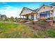 Charming backyard featuring a covered patio, outdoor seating, and a cozy fire pit perfect for entertaining at 2741 Morning Run Ct, Franktown, CO 80116