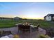 Outdoor firepit and patio seating area in the backyard with sunset views at 2741 Morning Run Ct, Franktown, CO 80116