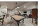 Spacious basement with a pool table, bar, living room area with tv, and access to the stairway at 2741 Morning Run Ct, Franktown, CO 80116