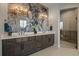 Elegant bathroom features double sinks, decorative wall art, and a luxurious glass-enclosed shower at 2741 Morning Run Ct, Franktown, CO 80116