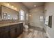 Modern bathroom with a glass-enclosed shower, granite countertops, and elegant tile flooring at 2741 Morning Run Ct, Franktown, CO 80116