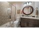 Stylish bathroom with a modern vanity, a walk-in shower with decorative tiles, and elegant fixtures at 2741 Morning Run Ct, Franktown, CO 80116