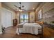 Comfortable bedroom featuring a rustic wooden bed frame, wood-paneled wall, and a view to the landscape at 2741 Morning Run Ct, Franktown, CO 80116