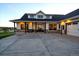 Inviting home with a covered porch, large windows, and a spacious driveway leading to the garage at 2741 Morning Run Ct, Franktown, CO 80116