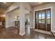 Elegant foyer with hardwood floors, stylish columns, and a view of the dining area at 2741 Morning Run Ct, Franktown, CO 80116