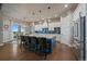 Bright kitchen with an island and seating area, modern appliances, and access to a dining space and outdoor views at 2741 Morning Run Ct, Franktown, CO 80116