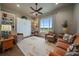 Cozy living room featuring neutral tones, comfortable seating, and a large window view at 2741 Morning Run Ct, Franktown, CO 80116