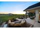 Inviting patio with outdoor seating area, fire pit, and stunning views of the surrounding landscape at sunset at 2741 Morning Run Ct, Franktown, CO 80116