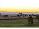 Scenic view of a house nestled amidst rolling hills and mountains at dusk at 2741 Morning Run Ct, Franktown, CO 80116
