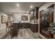 Finished basement bar features granite counter, mini fridge, and decorative door at 2741 Morning Run Ct, Franktown, CO 80116