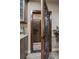 View of the wine cellar with an iron gate, wood racks, stone walls, and a small counter space near the entrance at 2741 Morning Run Ct, Franktown, CO 80116