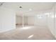 Unfinished basement with neutral carpeting and storage at 6190 W Canyon Ave, Littleton, CO 80128