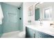 Modern bathroom with a teal tile shower and floating vanity at 6190 W Canyon Ave, Littleton, CO 80128