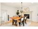 Bright dining room with a wood table, fireplace, and chandelier at 6190 W Canyon Ave, Littleton, CO 80128