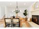 Dining area featuring a wood table and a modern fireplace at 6190 W Canyon Ave, Littleton, CO 80128