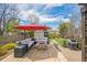 Backyard featuring a stone patio with outdoor seating and a grill at 9361 Crestmore Way, Littleton, CO 80126