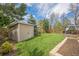 Well-maintained backyard with green lawn, storage shed, and deck with gazebo, perfect for outdoor relaxation and entertainment at 9361 Crestmore Way, Littleton, CO 80126