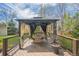Backyard deck featuring a gazebo with curtains, table, and chairs at 9361 Crestmore Way, Littleton, CO 80126