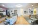 Open basement area with hardwood floors, brick fireplace and track lighting at 9361 Crestmore Way, Littleton, CO 80126