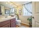 Powder room with wood floors, a plant, and neutral-toned walls at 9361 Crestmore Way, Littleton, CO 80126
