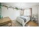 Bright bedroom with wood floors, shelving, and a decorative pink chandelier at 9361 Crestmore Way, Littleton, CO 80126