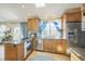 Well-lit kitchen featuring modern stainless steel appliances and ample counter space at 9361 Crestmore Way, Littleton, CO 80126