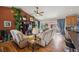 Cozy living room with hardwood floors, vaulted ceilings, a ceiling fan and access to the patio at 9361 Crestmore Way, Littleton, CO 80126