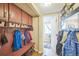 Mudroom with built-in storage, coat hooks, and an open doorway at 9361 Crestmore Way, Littleton, CO 80126