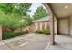 Cozy backyard with a concrete patio, partial fence and mature greenery, providing a private retreat at 490 Jackson St, Denver, CO 80206
