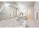 Well-lit bathroom featuring dual vanities, a soaking tub, and elegant fixtures at 490 Jackson St, Denver, CO 80206