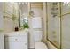 Bathroom featuring tile and glass shower doors, a vanity with storage, and decorative gold fixtures at 490 Jackson St, Denver, CO 80206