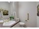 Bathroom featuring gold fixtures, a vanity with countertop, and a toilet with grab bars at 490 Jackson St, Denver, CO 80206