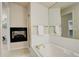 Bathroom featuring a soaking tub, fireplace, and luxurious fixtures in a well-lit space at 490 Jackson St, Denver, CO 80206