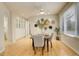 Bright dining room featuring hardwood floors, white cabinetry, and a decorative wall arrangement with large windows at 490 Jackson St, Denver, CO 80206