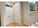Bright entryway with hardwood floors, featuring a front door, closet, and staircase leading to the upper level at 490 Jackson St, Denver, CO 80206