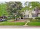 Charming home exterior featuring lush greenery, a well-manicured lawn and large windows at 490 Jackson St, Denver, CO 80206