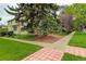 Home exterior showcasing a spacious yard, healthy tree coverage, and sidewalk access at 490 Jackson St, Denver, CO 80206