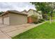 Charming home featuring a two-car garage, private fenced yard, and beautifully landscaped front lawn at 490 Jackson St, Denver, CO 80206