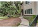 Landscaped front yard and walkway leading to the home's entrance, with a mature tree providing shade and curb appeal at 490 Jackson St, Denver, CO 80206