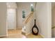 Open hallway with hardwood floors, showcasing staircase and a decorative vase, creating an inviting transition at 490 Jackson St, Denver, CO 80206
