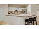 Modern kitchen with white cabinets, stainless steel appliances, a breakfast bar with seating and plenty of counter space at 490 Jackson St, Denver, CO 80206