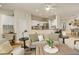 Open-concept living room with hardwood floors, a fireplace, and views into the kitchen and dining areas at 490 Jackson St, Denver, CO 80206