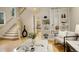 Stylish living room featuring hardwood floors, staircase, and a decorative vase, creating an inviting transition at 490 Jackson St, Denver, CO 80206